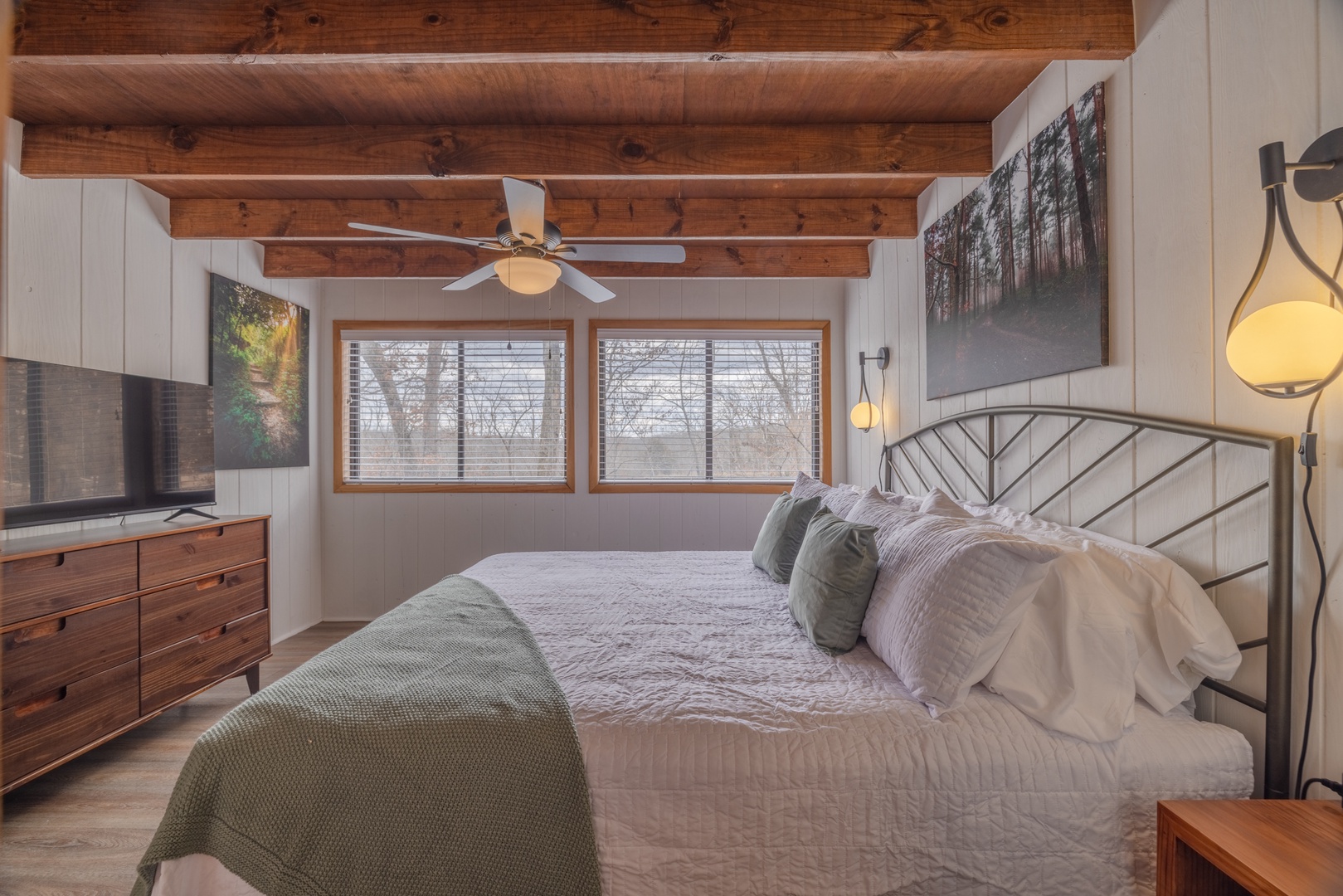 Bedroom 1 -The king sized bed and premium bedding will give you restful sleep with the charming wooded views. “Would stay again” - Felix the Cat