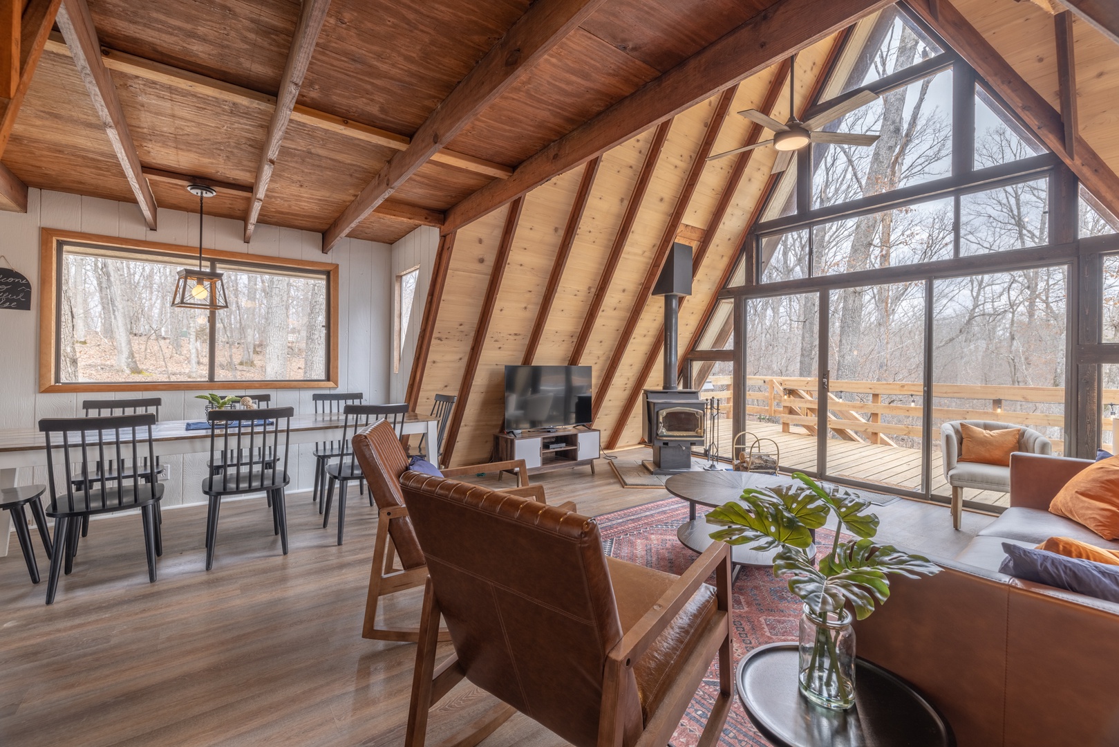 The living area is complete with a 55” TV and a cozy wood stove.