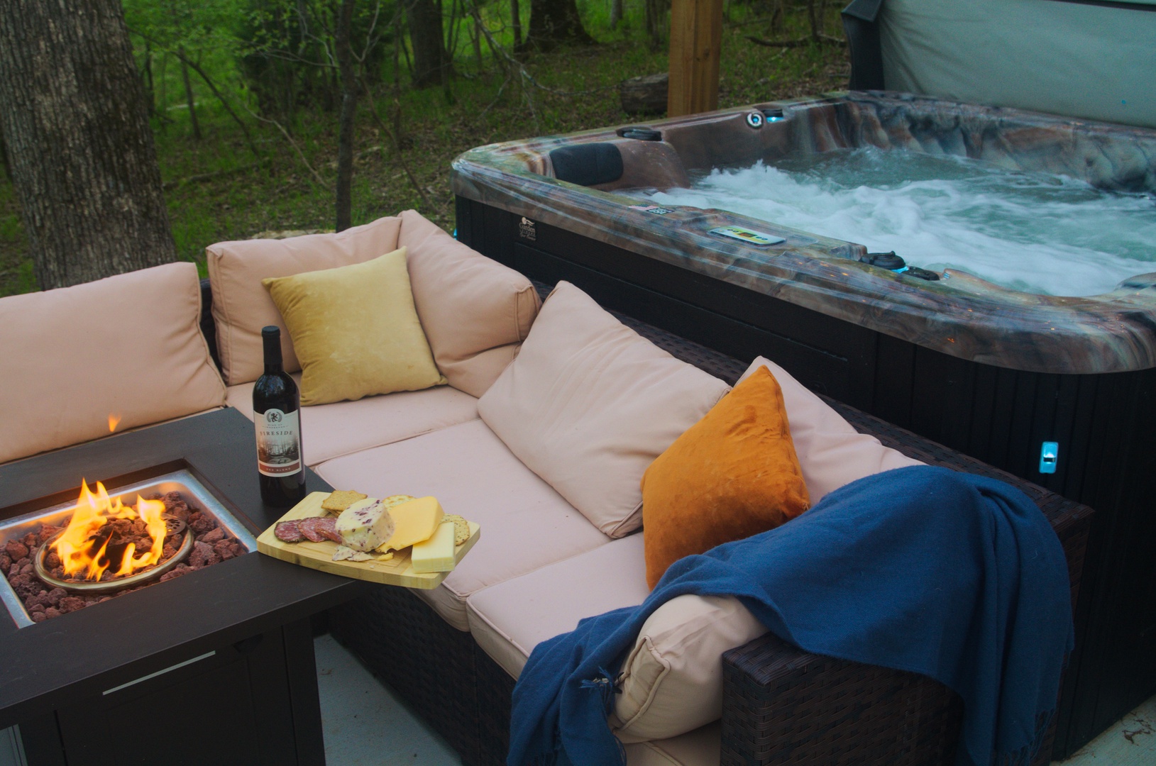 Unwind in the hot tub or cozy up in front of the fire table as you take in the pleasant forest views at Restful Ridge . “Great experience!” - Jordan