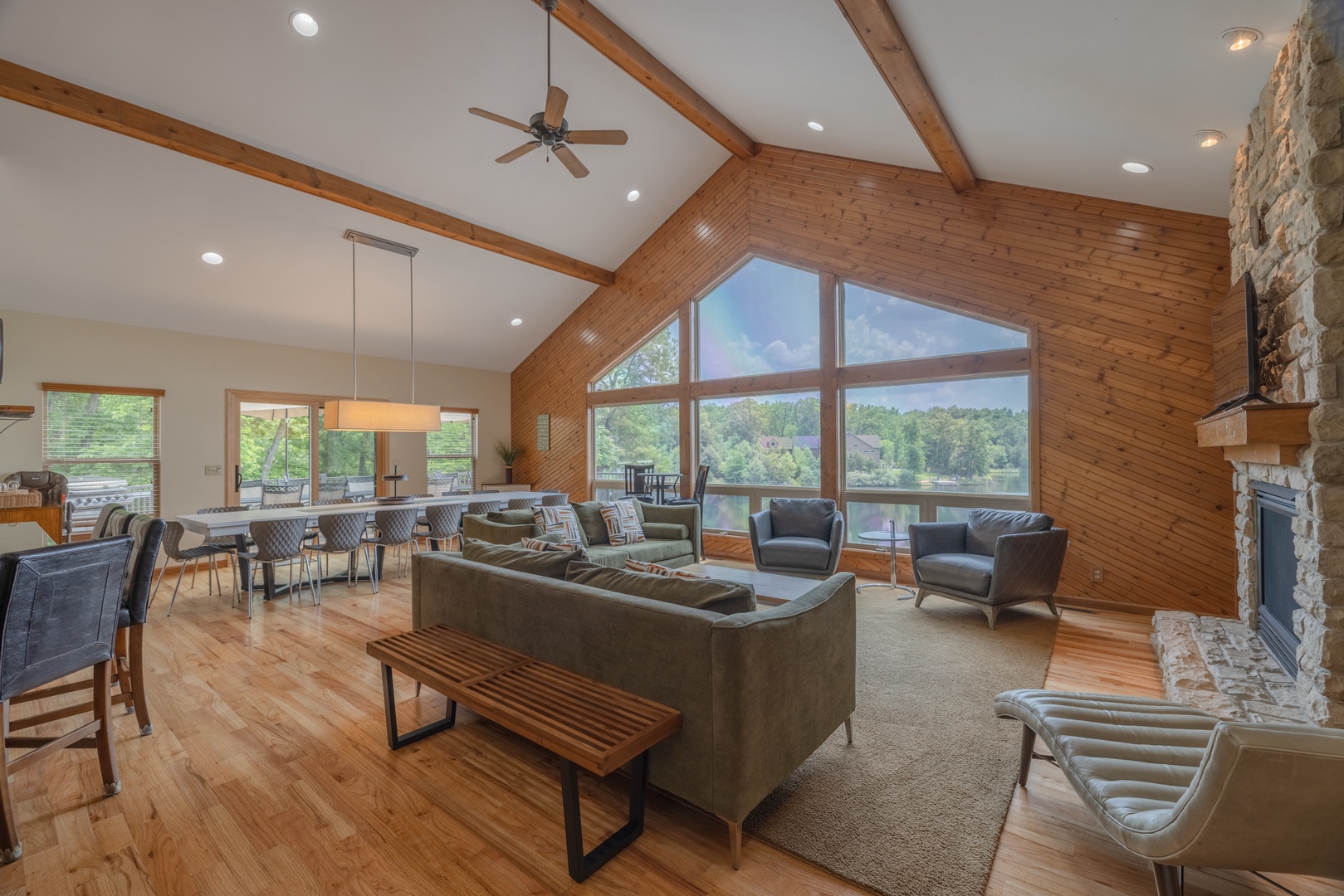 Spacious, open living area with an expansive wall of windows overlooking Lake Charrette