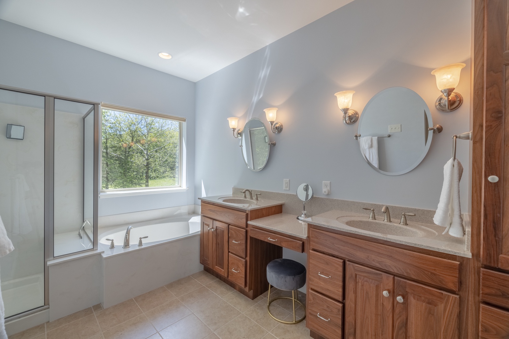 En Suite primary bathroom with double vanity sinks and a separate tub and standing shower