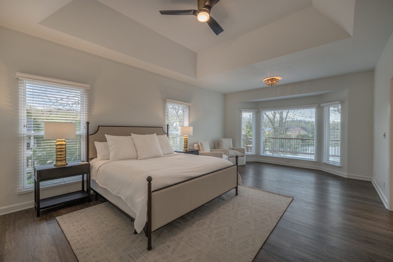 The beautiful primary suite outfitted with one king bed and amazing views of Lake Charrette
