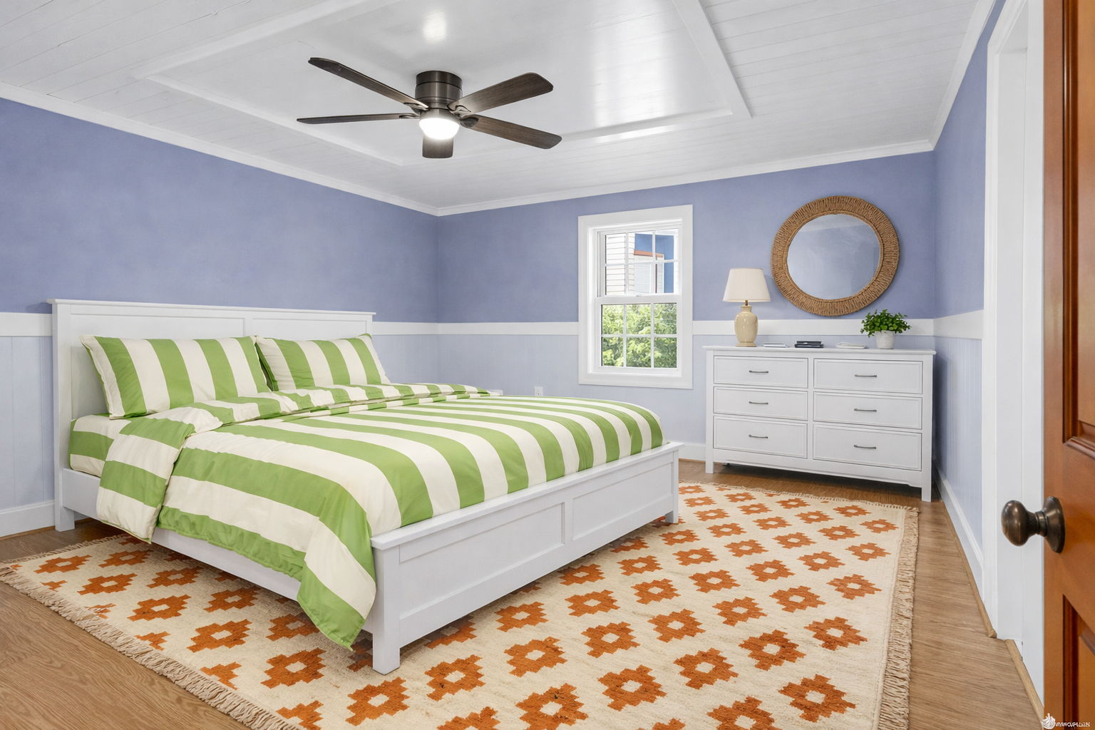 Sleep peacefully in your bright bedroom with soothing blue walls, cozy striped bedding, and a gentle ceiling fan overhead.