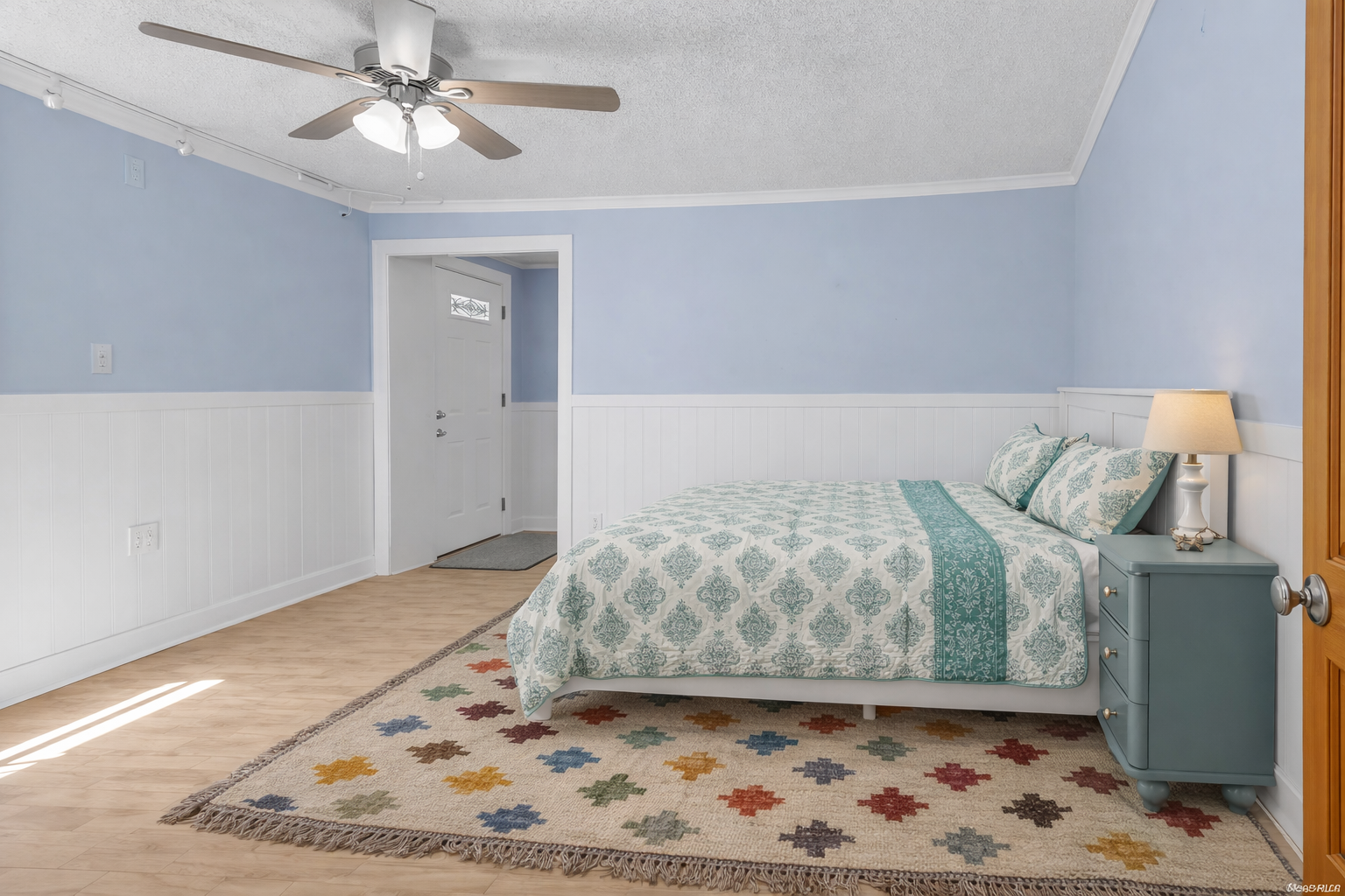Drift off to sleep in this peaceful bedroom where soft blue walls and coastal-inspired bedding create your perfect retreat.