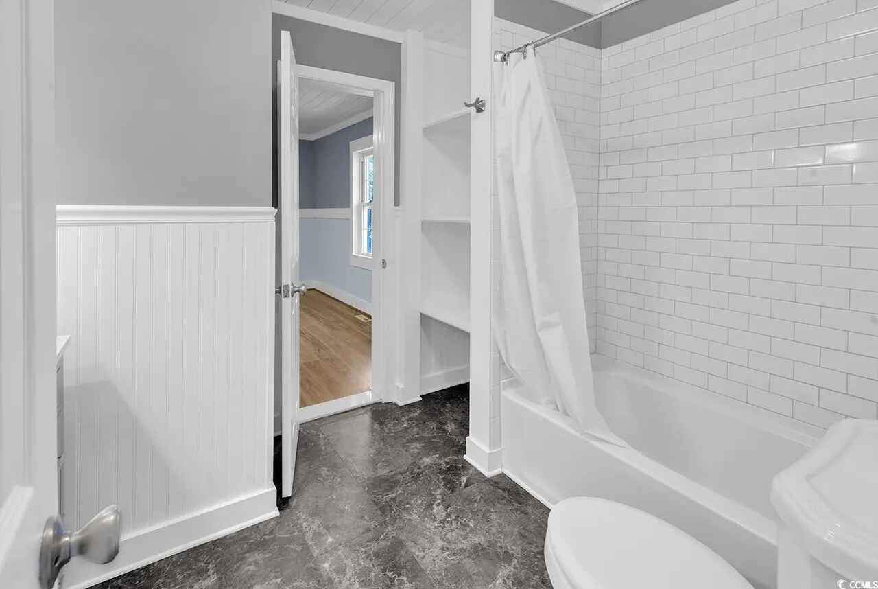 Unwind in your pristine bathroom featuring subway tile walls and a deep soaking tub perfect for relaxing evenings.
