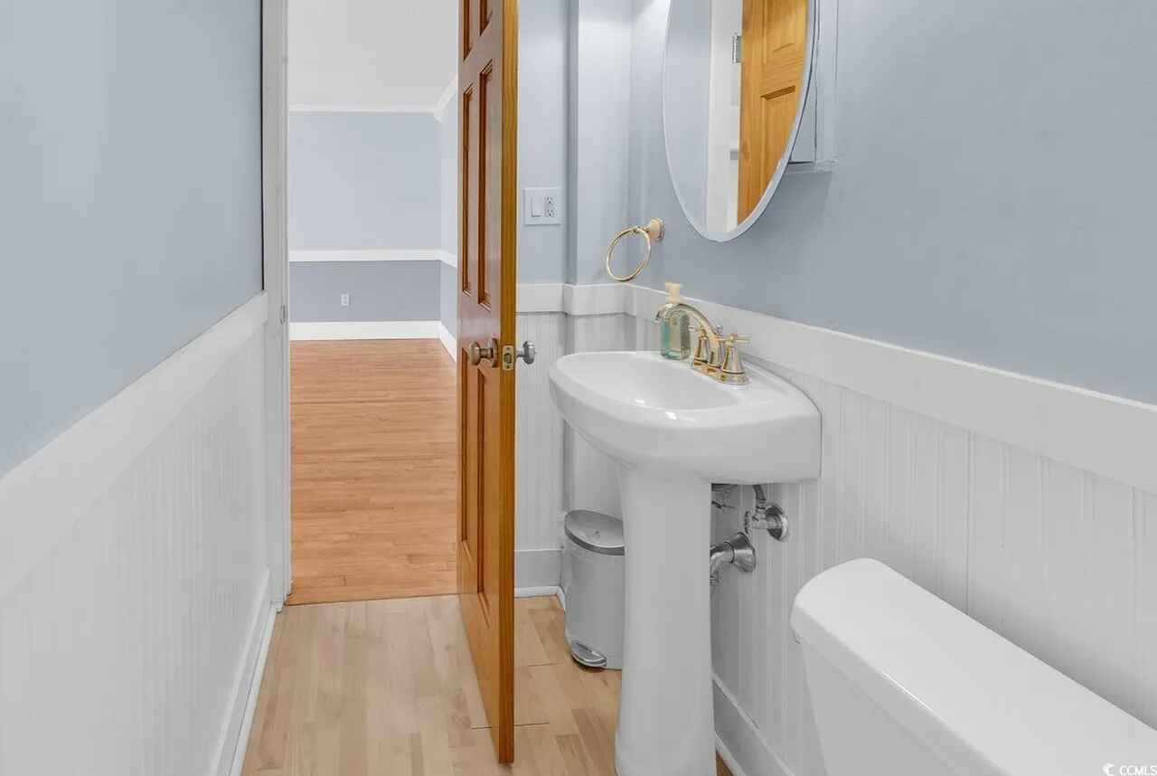 Your private bathroom features classic blue and white styling with a pedestal sink and vintage charm.