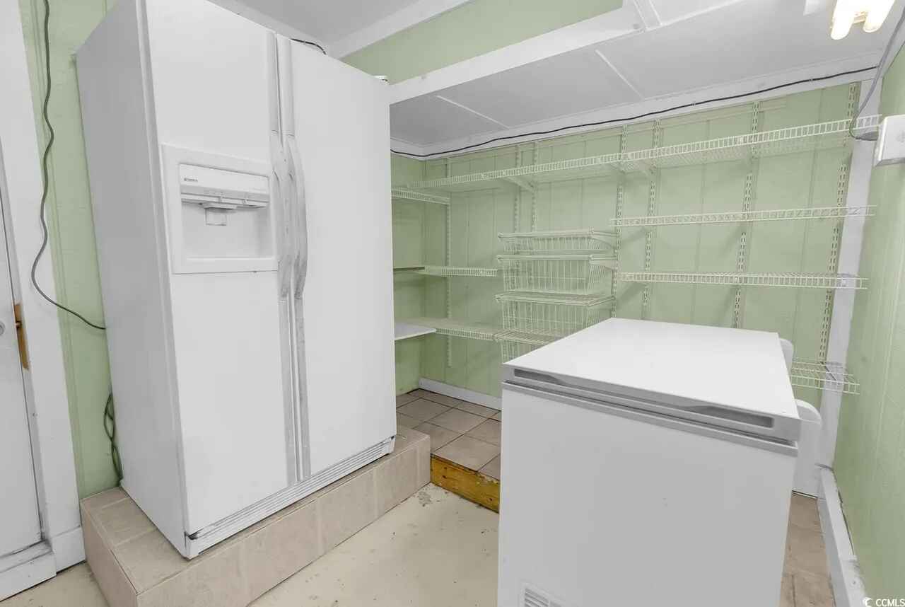 Your private pantry features a full-size refrigerator and freezer with wire shelving for all your groceries and meal prep needs.
