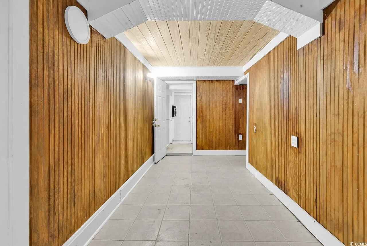 Clean, modern hallway with warm wood paneling creates a welcoming entrance to your private retreat.