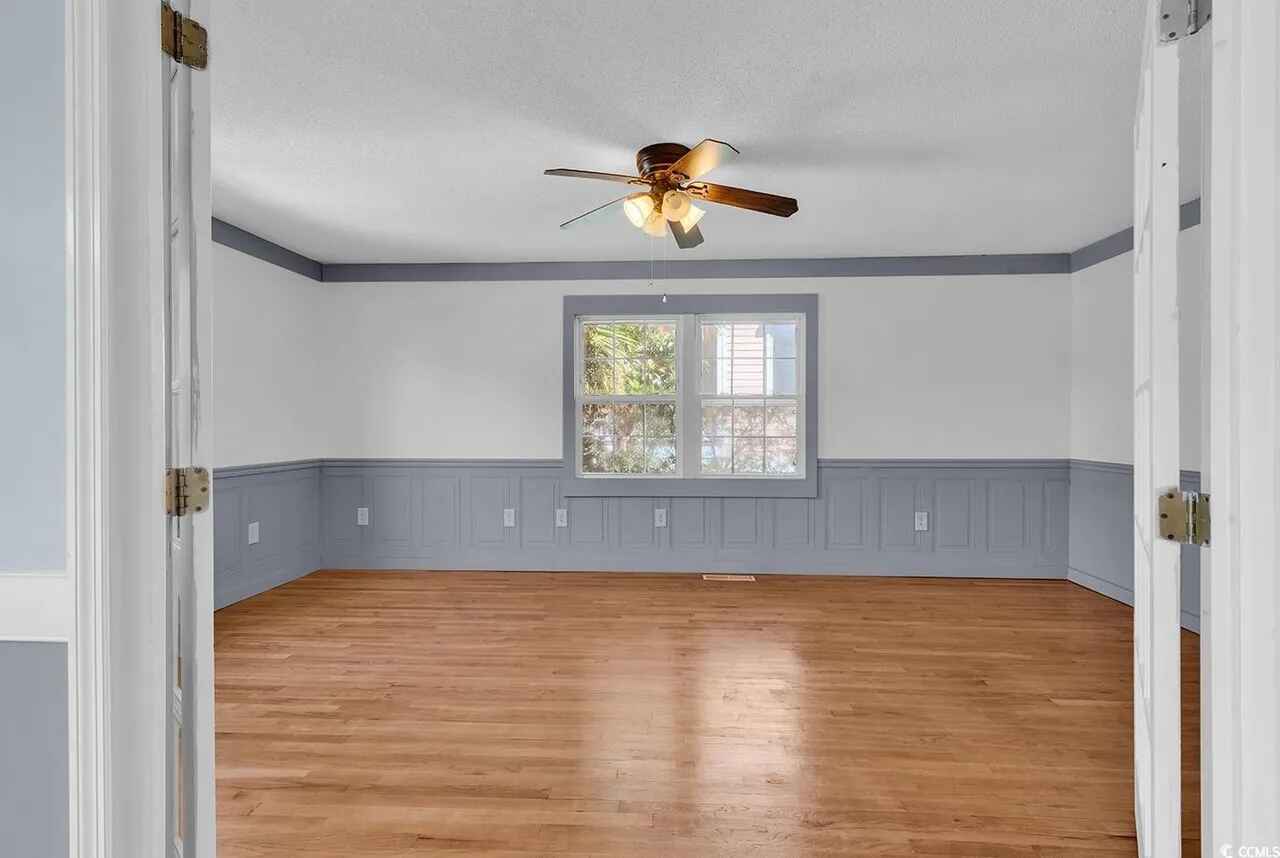 Your spacious room features gleaming hardwood floors, elegant wainscoting, and a ceiling fan to keep you comfortable year-round.