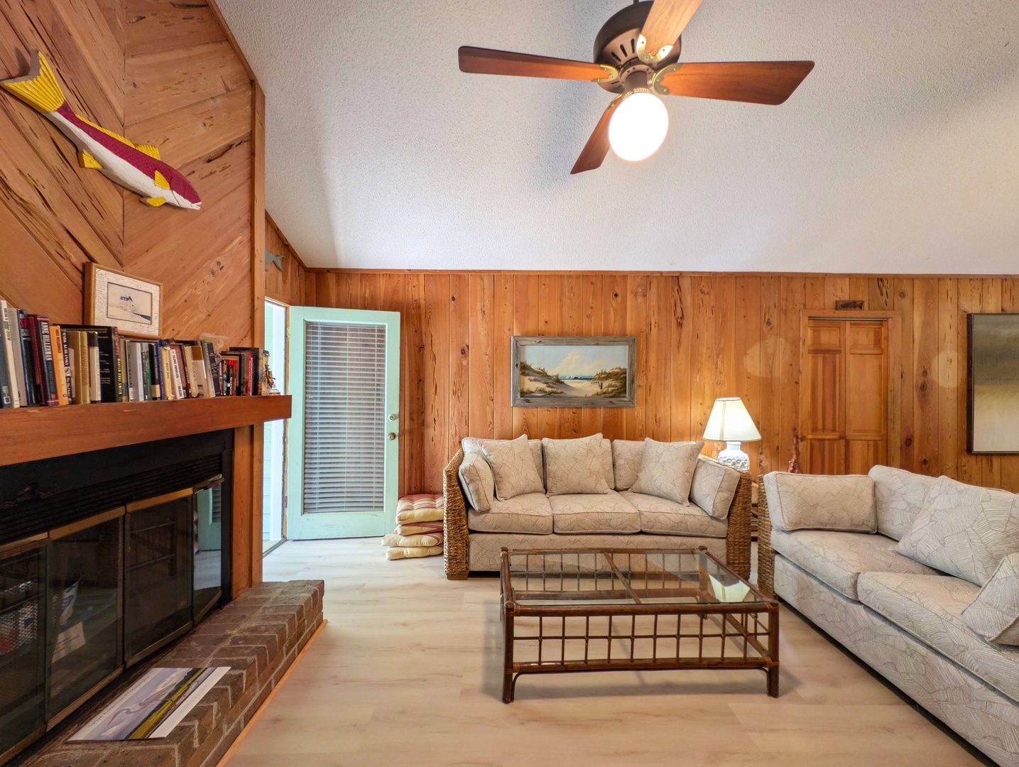 Unwind in your cozy living space with warm wood paneling, plush seating, and a charming fireplace. Vaulted ceilings and soft lighting create the perfect retreat after your day's adventures.