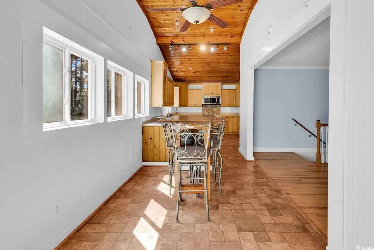 Your bright kitchen flows seamlessly into the dining area, where warm wood accents and natural light create the perfect gathering space.