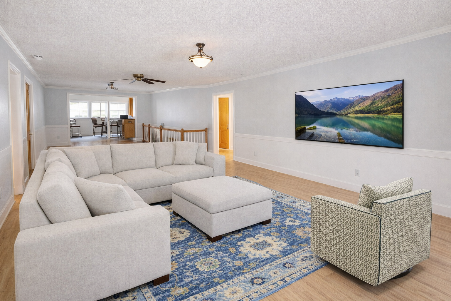 Sink into plush sectional seating where your movie nights come alive on the large wall-mounted TV in this bright, open living space.