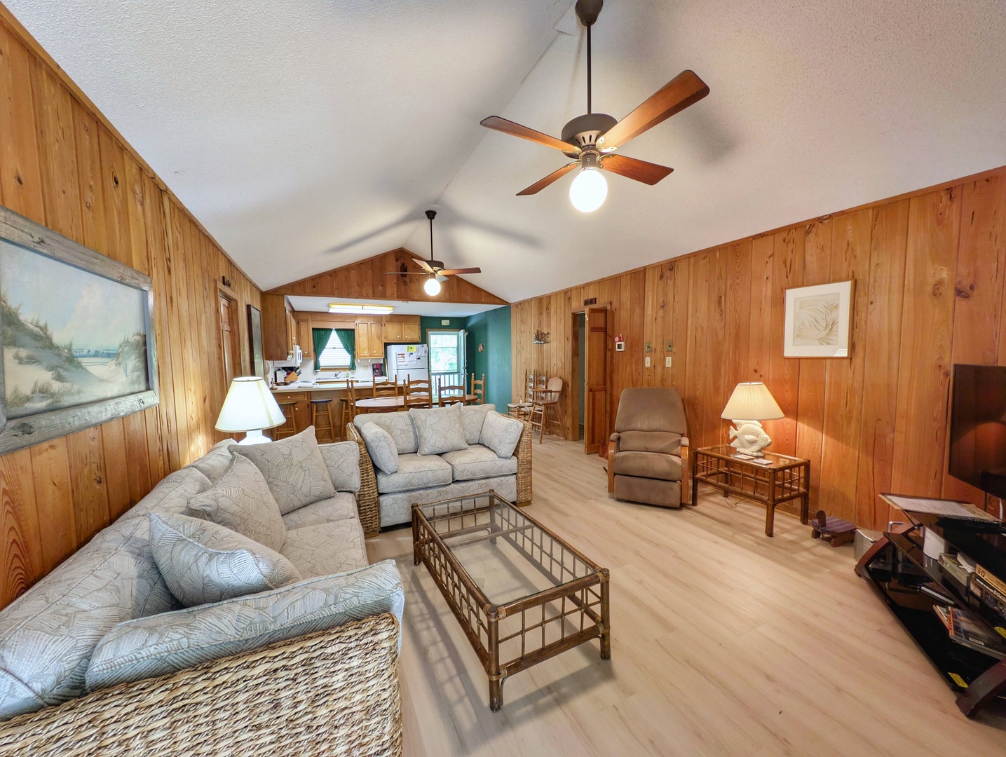 Settle into your spacious living room with vaulted ceilings, soft seating, and warm wood accents. Your open-concept retreat invites you to relax, gather, and unwind in cozy comfort.