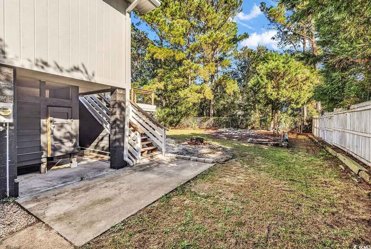 Step onto your private patio where peaceful moments await amid lush greenery and natural beauty surrounding this modern retreat.
