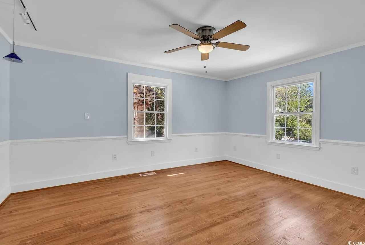 This bright, airy room features beautiful hardwood floors and a ceiling fan to keep you comfortable year-round.