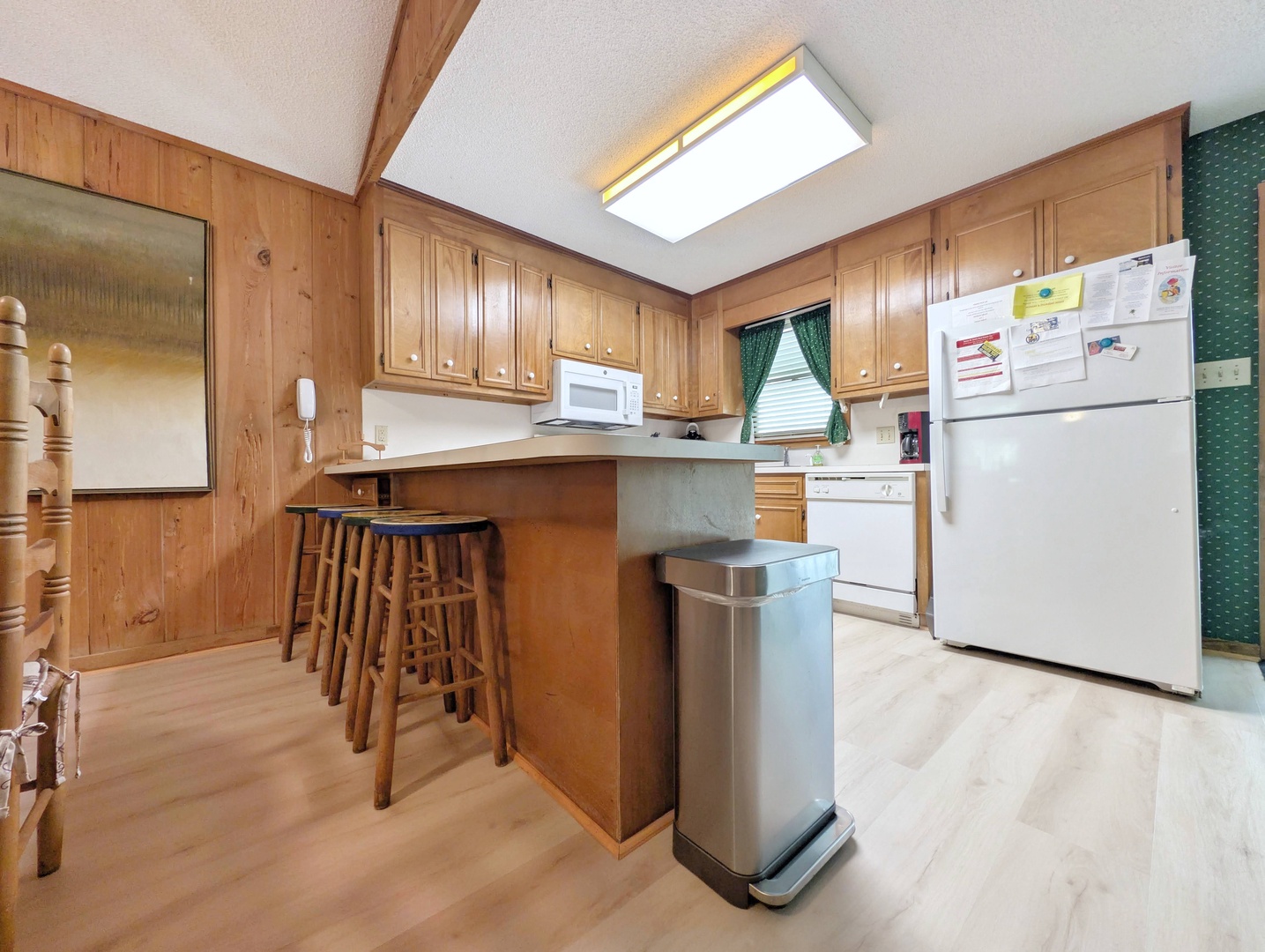 Your fully equipped kitchen has everything you need—warm wood cabinets, a breakfast bar for quick meals, and all the essentials to whip up your favorite dishes anytime.