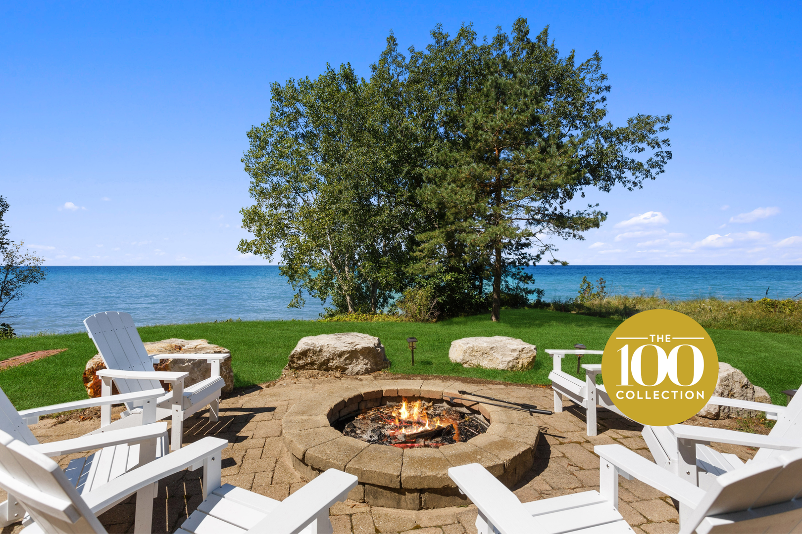 Gather with friends and family around the sandstone patio & firepit overlooking Lake Michigan at Costal Cottage part of the 100 Collection