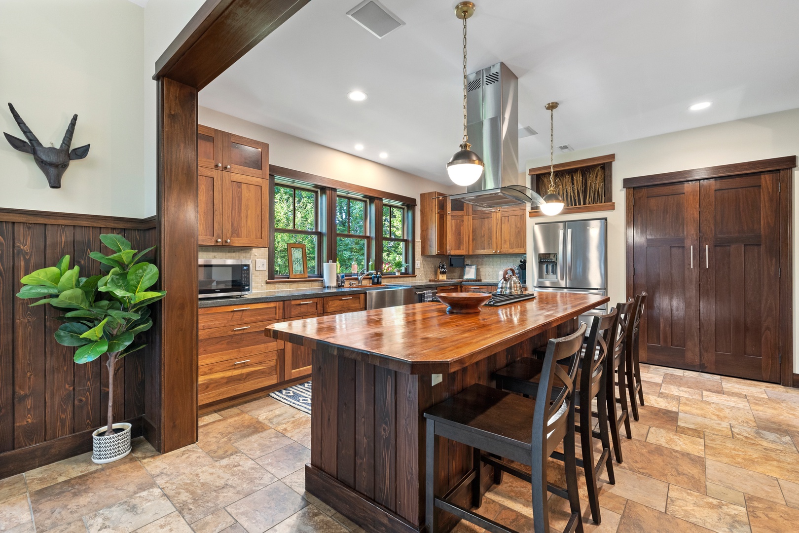 Large windows overlooking the outdoors grace the open kitchen.
