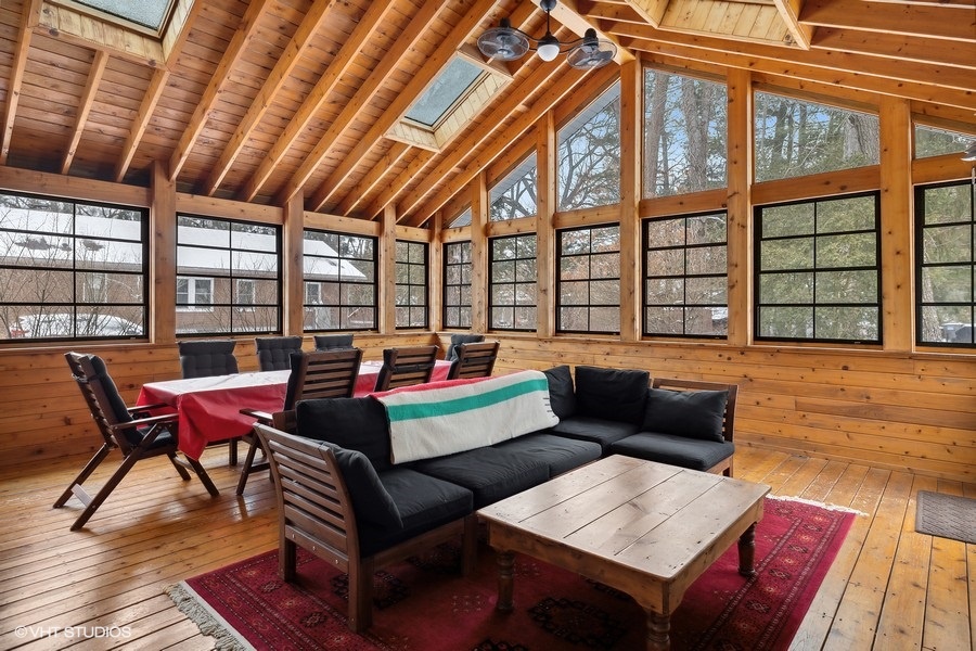 Unwind in this stunning sitting room with wood paneling and ample natural light.
