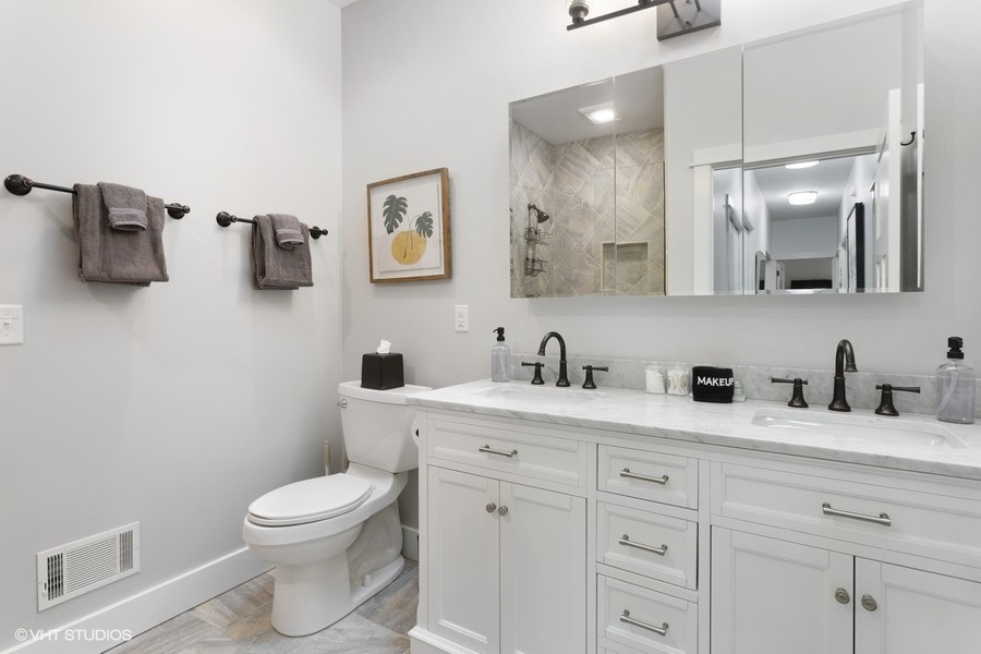 Both full baths feature granite-topped double-sinks and tiled showers.