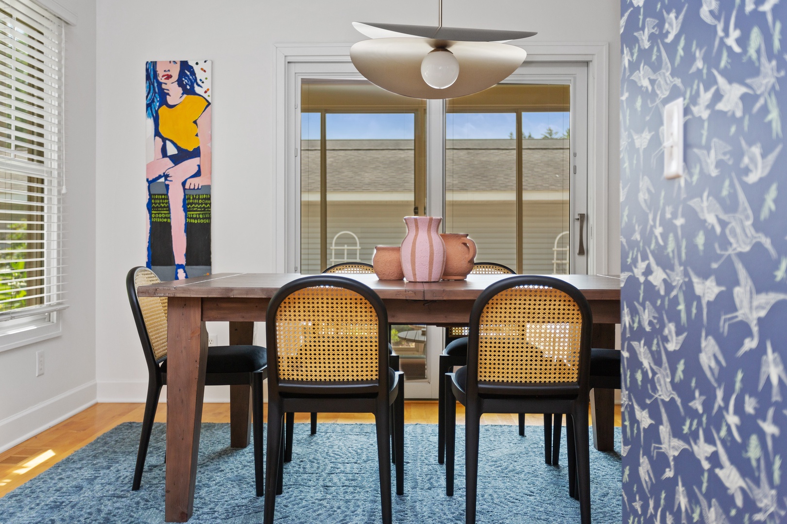 The sleek dining room opens to a lovely screened, slate-floored porch.