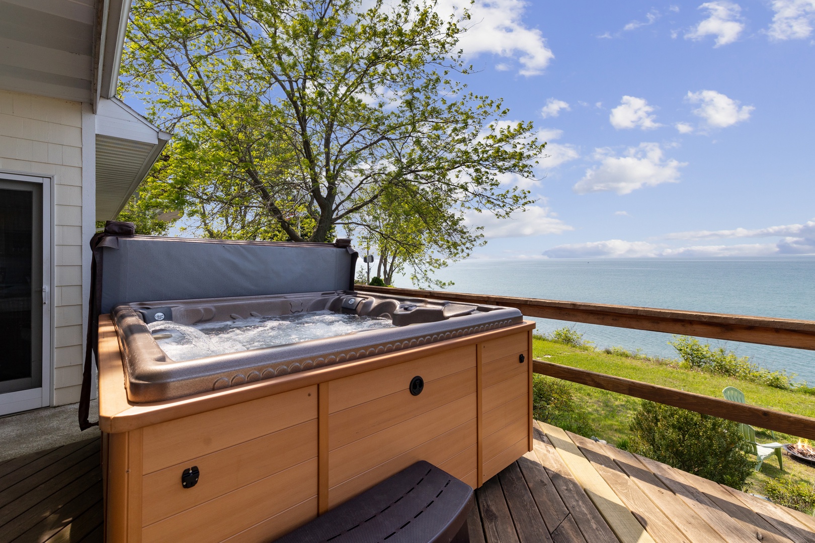The hot tub and back deck boast breathtaking views of Lake Michigan.