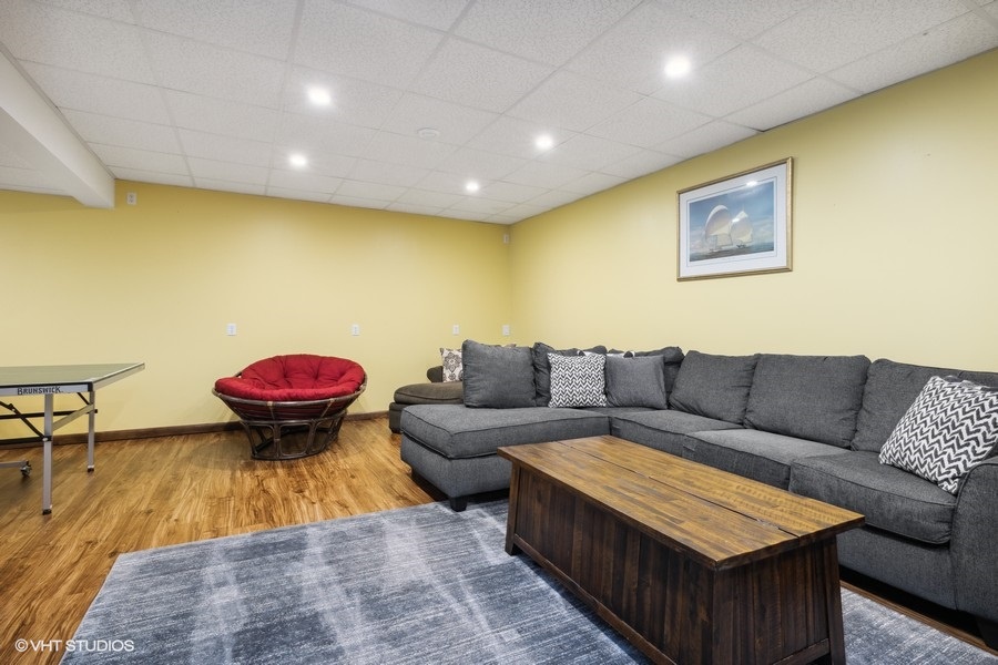 Unwind in the downstairs living room, complete with a large sectional and flat-screen TV.