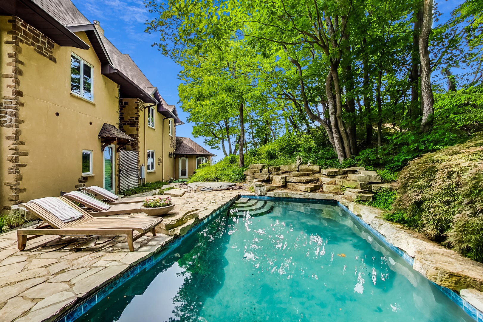 Enjoy a dip in the pool, not to mention the sweet landscaping all around it.