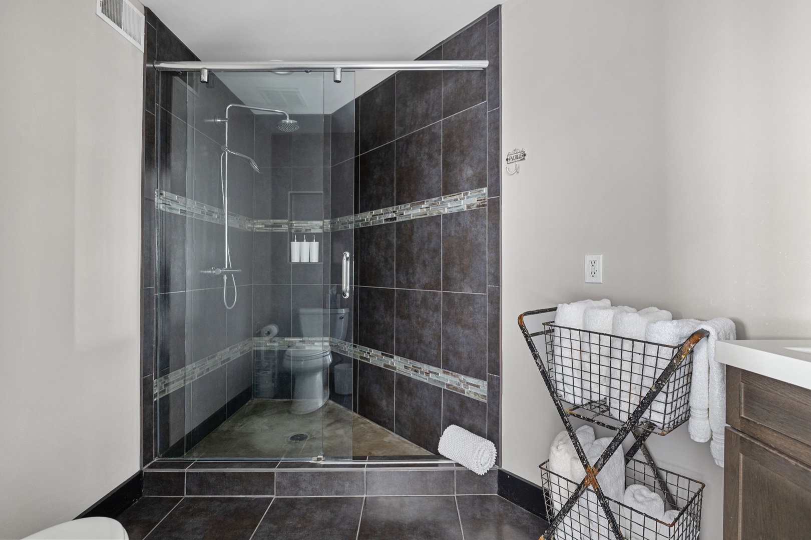 Richly appointed, this elegant bathroom is enhanced by a tiled walk-in shower.