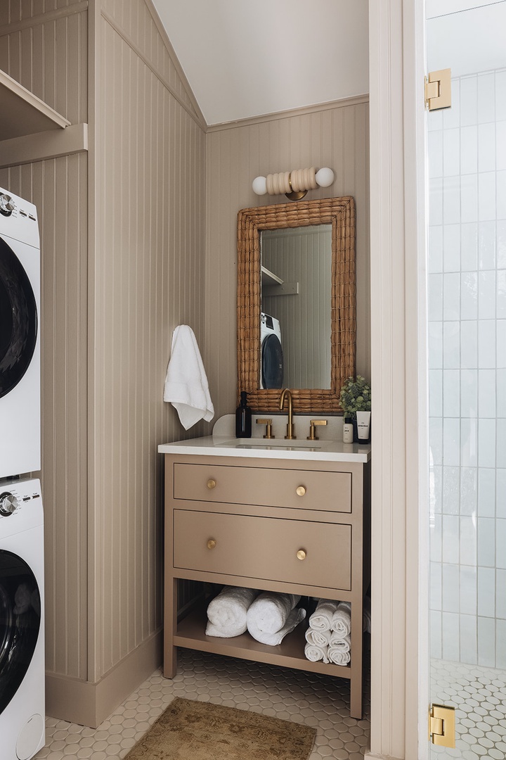 This super-chic bathroom also houses a high-end stackable washer-dryer. Boom.