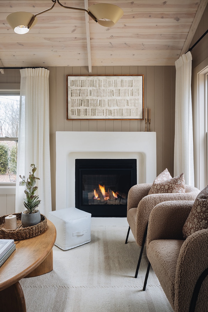 Lots to love about a living room fireplace and a glass of your fave beverage.