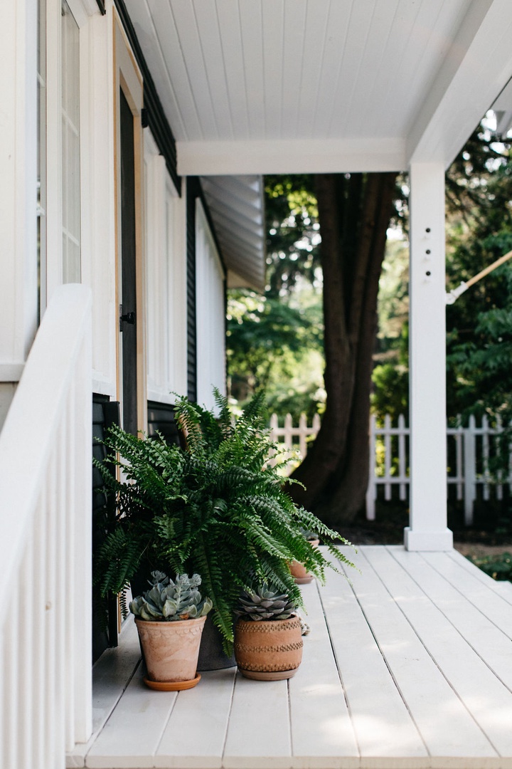 The Cottage’s front porch is a serene haven overlooking nature’s canvas.