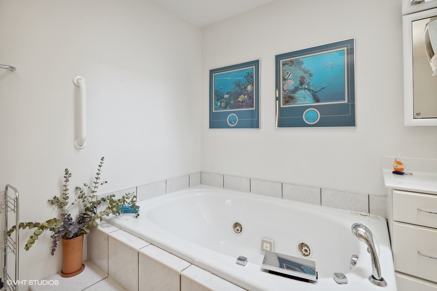 The ensuite bathroom features a soaking tub, perfect for a relaxing soak at the end of the day.