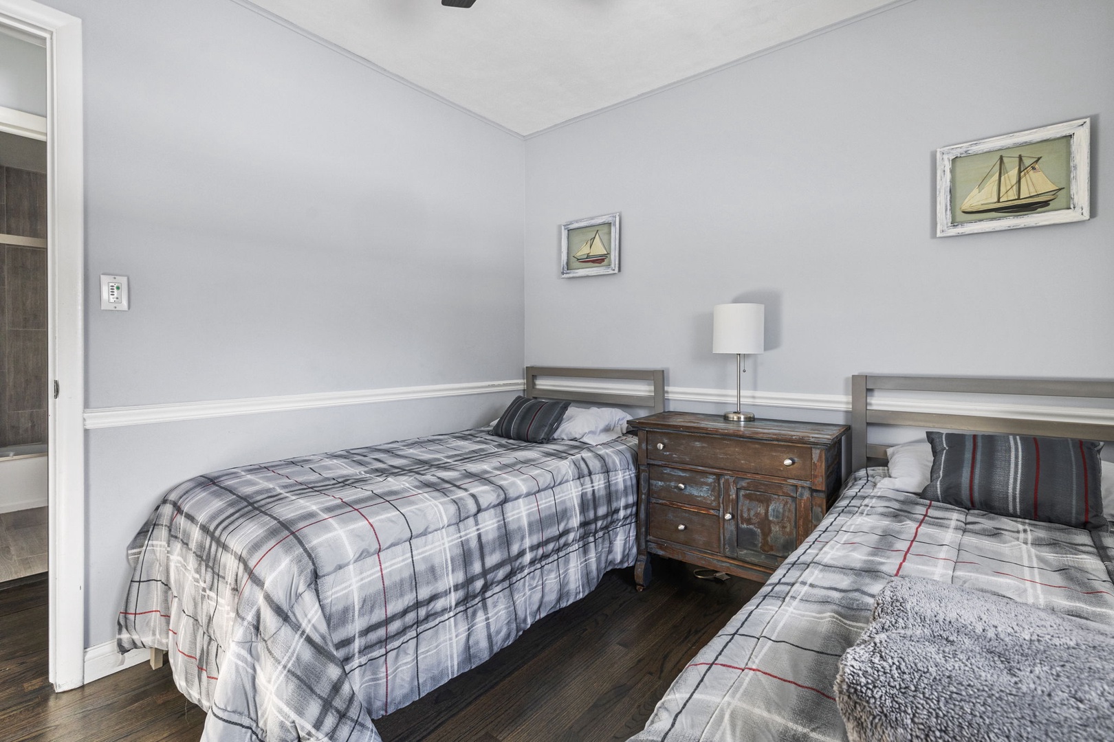 This sweetly-appointed bedroom features two super-comfy single beds.