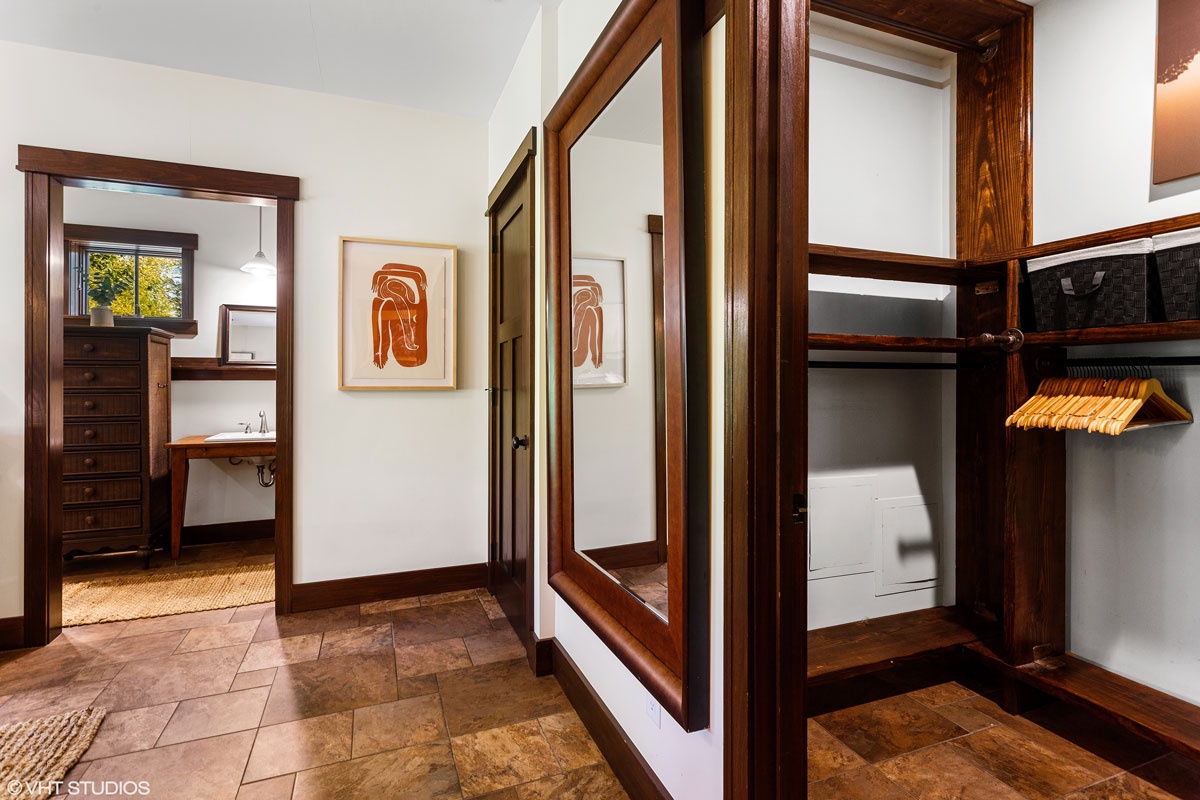 There is ample storage in the primary bedroom's closet to tuck away all of your travel gear.