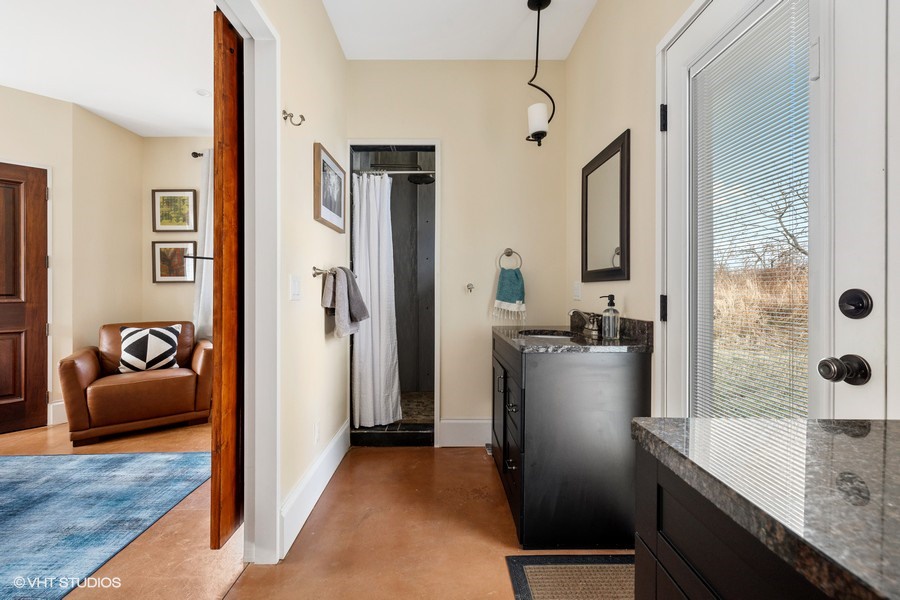 The main ensuite has twin sinks, a faux-marble vanity and a walk-in shower.
