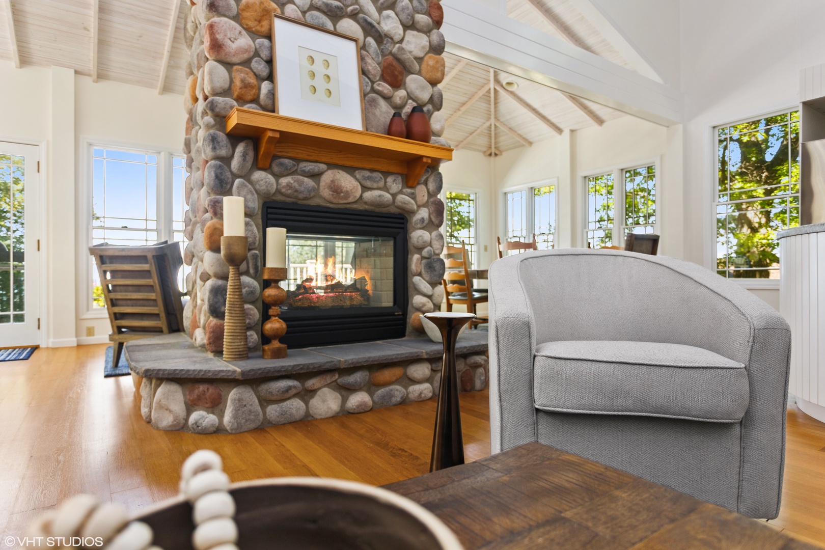 A stone and glass double sided gas fireplace provides cozy ambiance year-round.