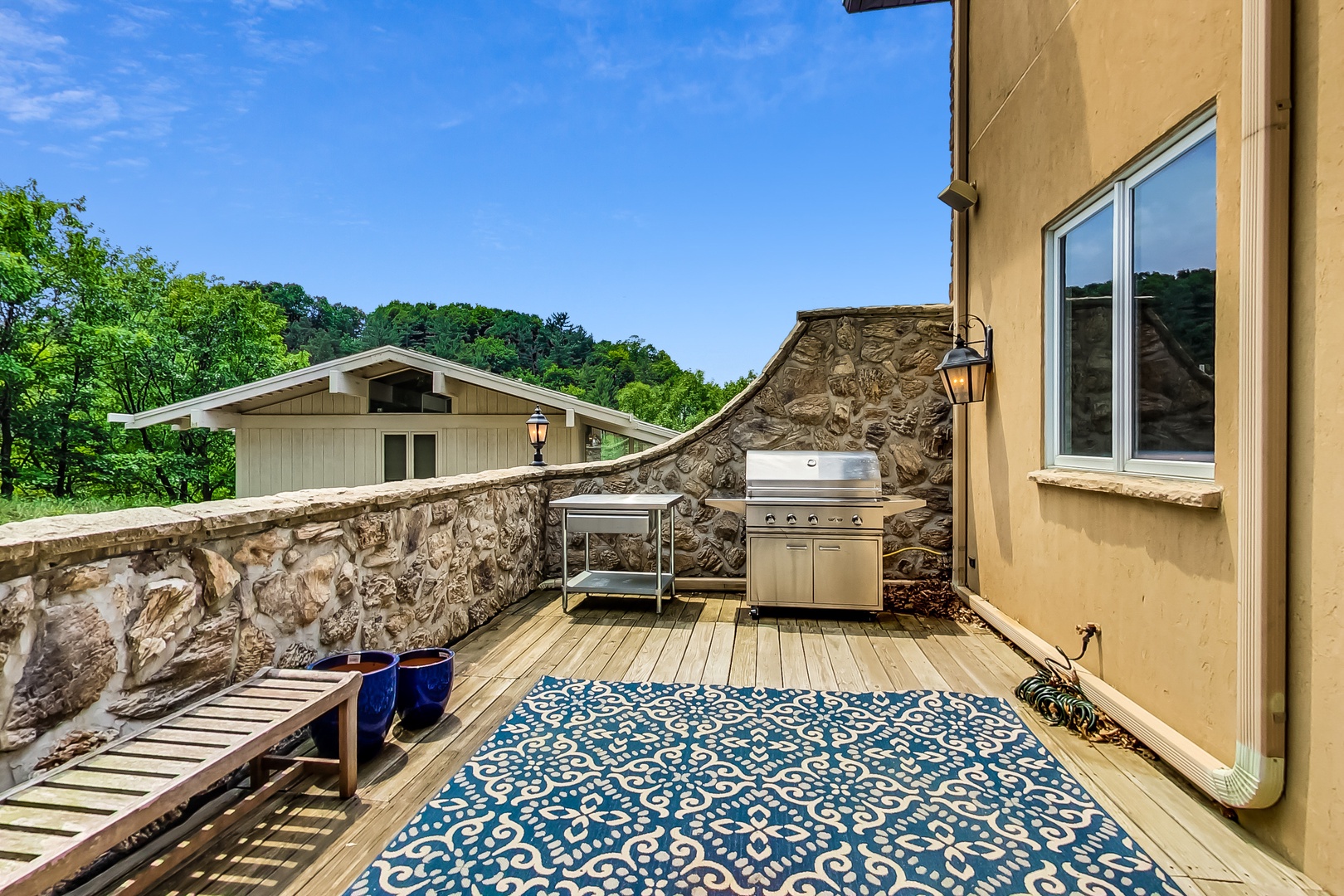 Comfortable seating and a top-of-the-line barbecue grill is on the back deck.