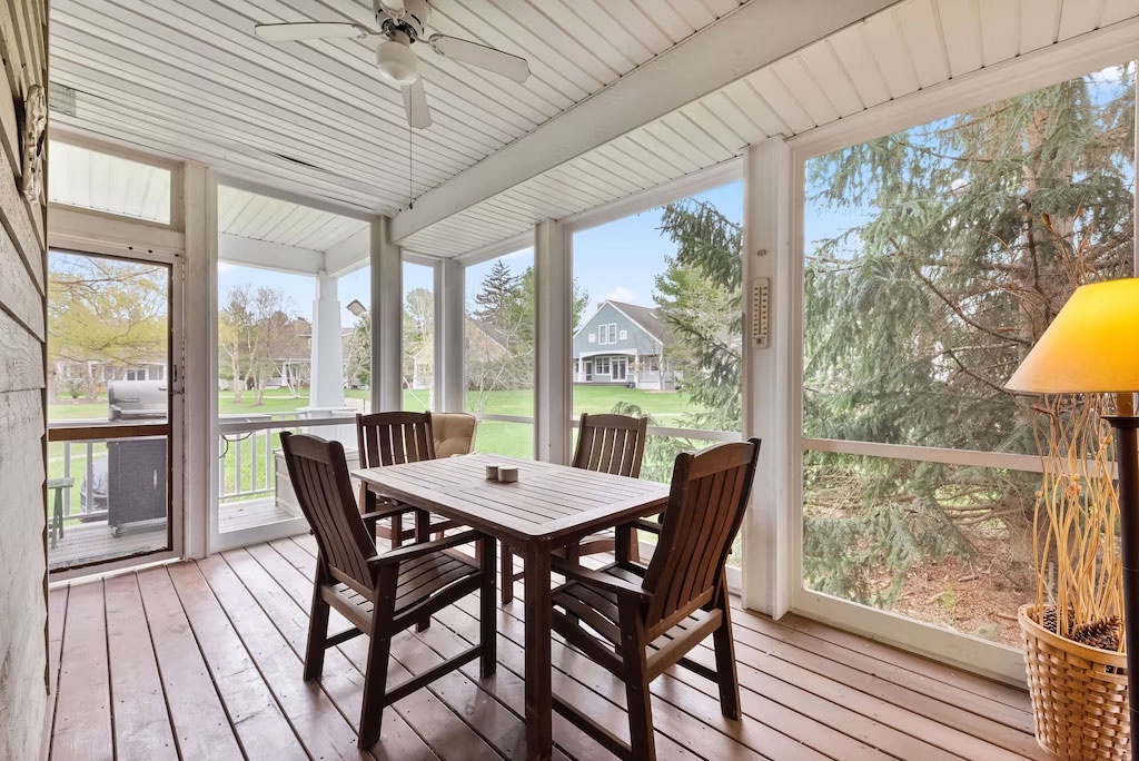 Relax and enjoy some fresh air and conversation on this cozy screened-in porch.