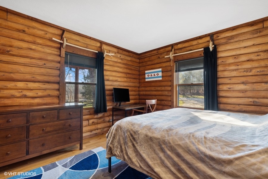 Unwind in this tranquil bedroom, surrounded by rustic finishes and picturesque views.