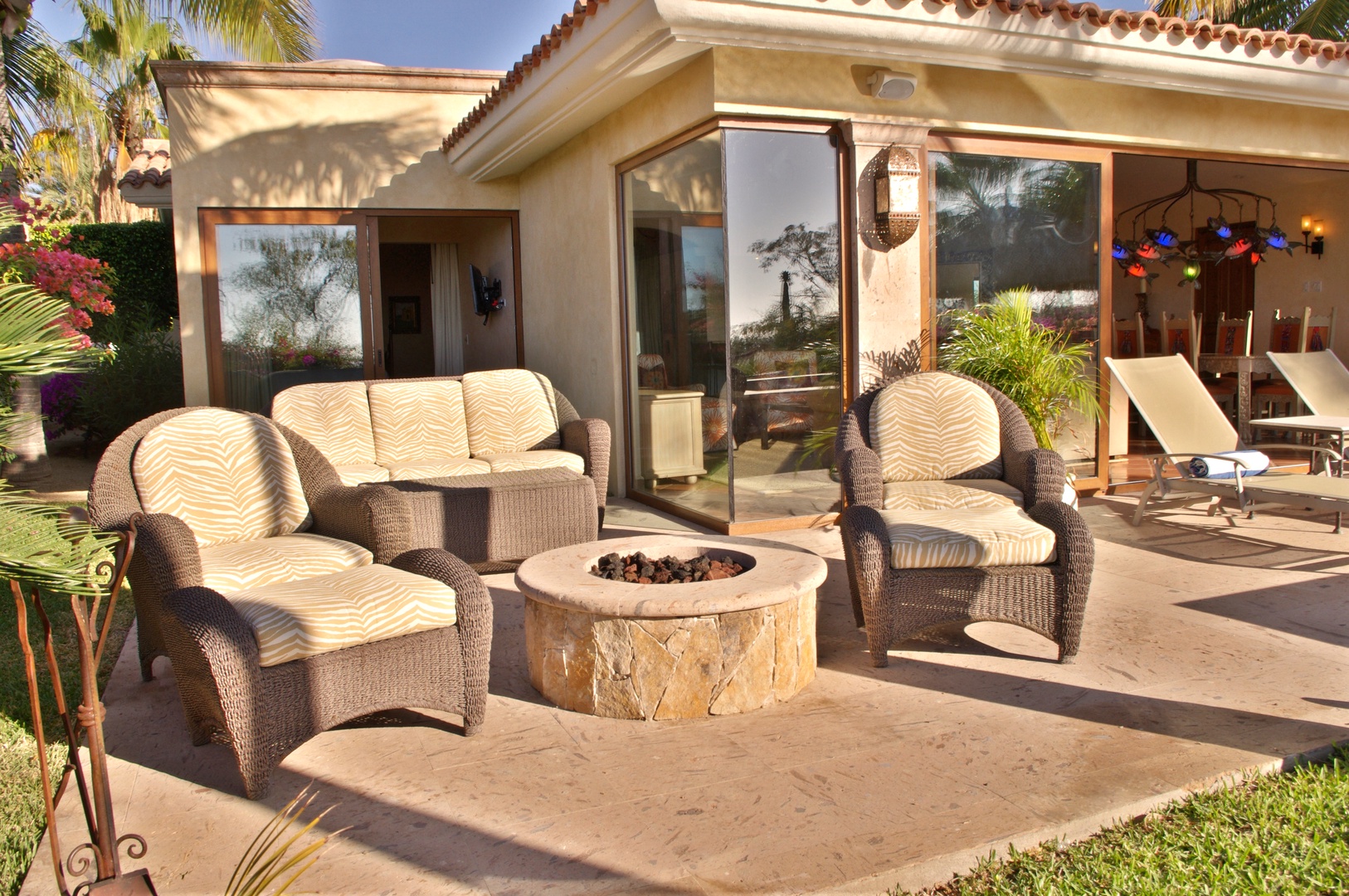 Unwind on your private patio with plush seating around the fire pit, where warm evenings and tropical breezes set the scene for unforgettable moments.
