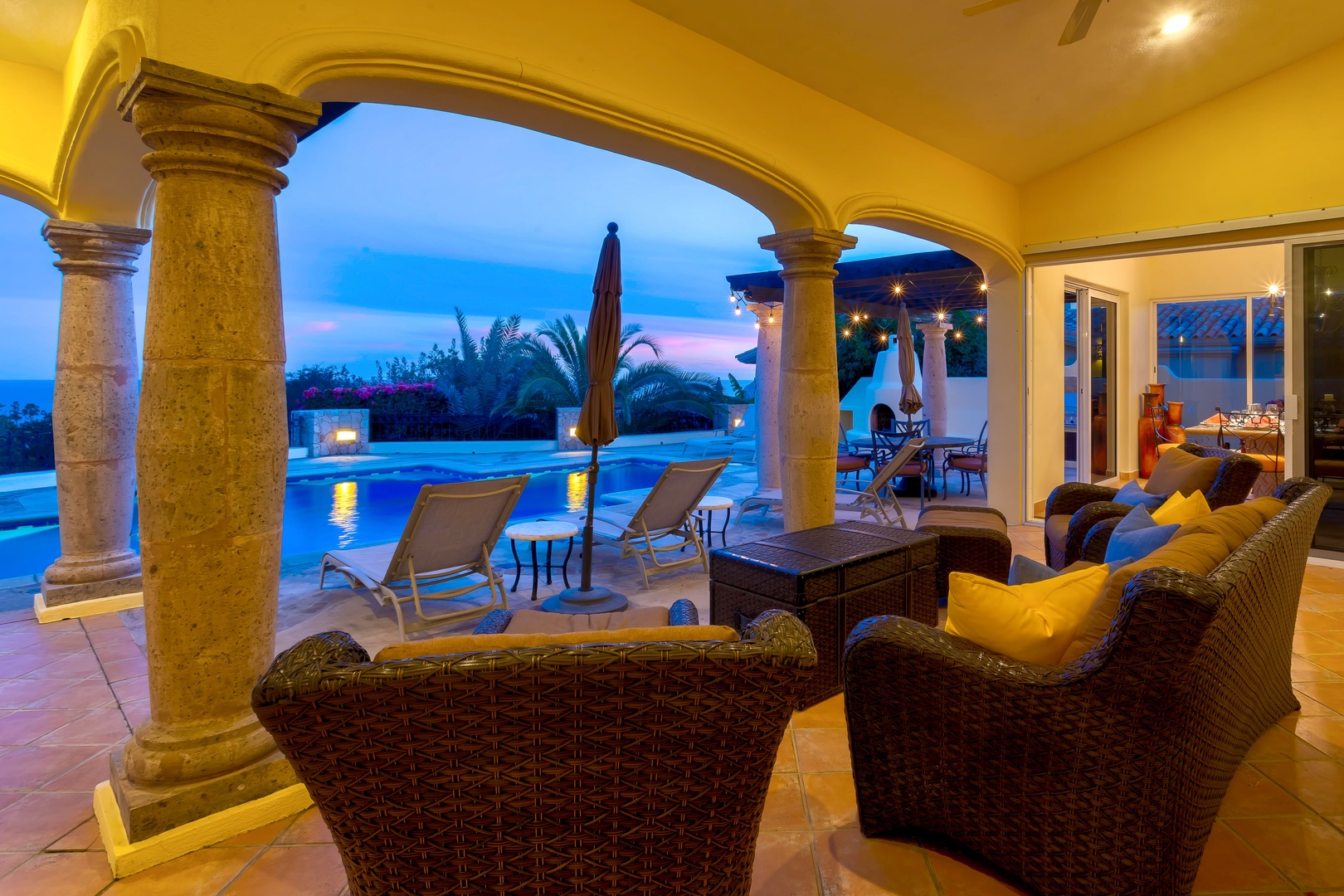 Unwind in elegant wicker seating while enjoying stunning twilight views over your private pool and tropical gardens.
