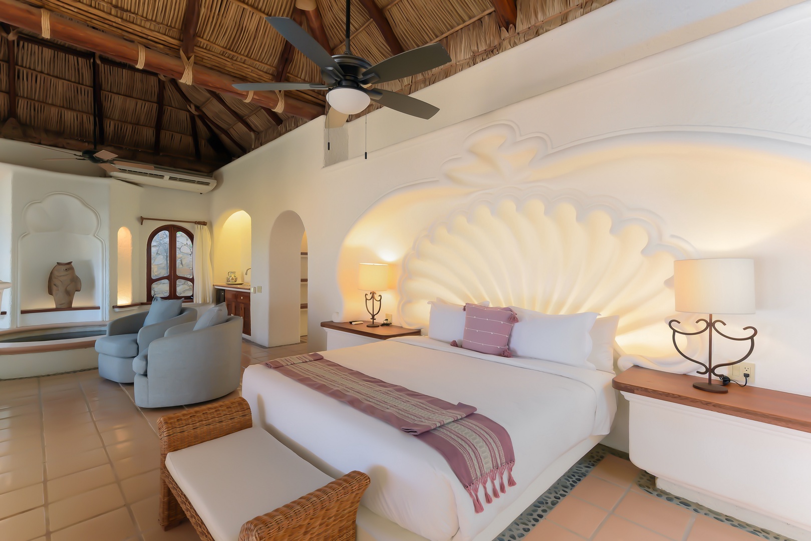 You'll fall in love with this sanctuary's thatched palapa ceiling and glowing shell headboard, where crisp linens and tropical elegance invite pure relaxation.