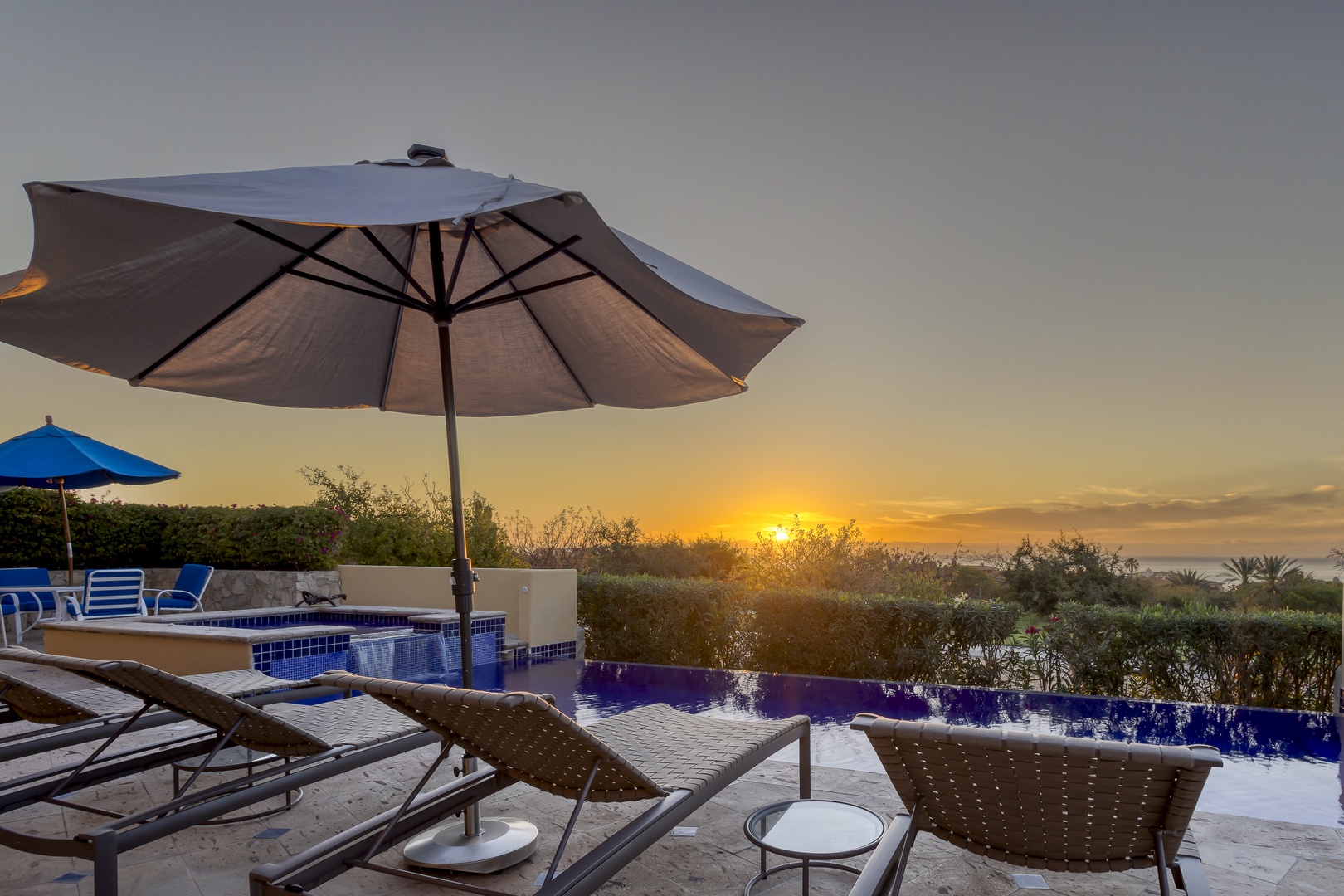 Stunning sunset views from the pool terrace, where golden hour light creates the perfect backdrop for your evening relaxation.