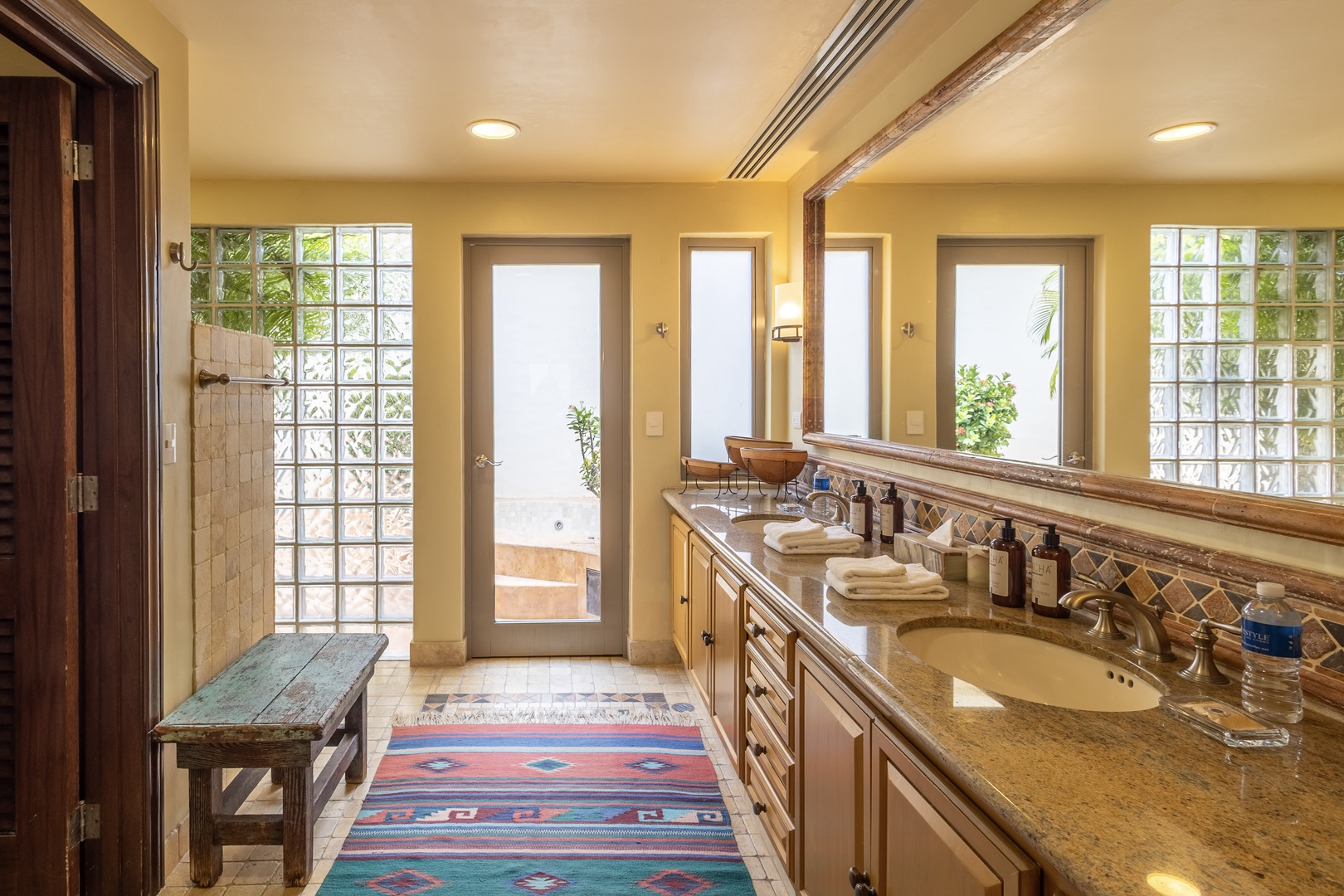 Step into your private spa-like retreat with warm natural light, dual vanities, and a soothing palette that invites you to unwind in style and comfort.