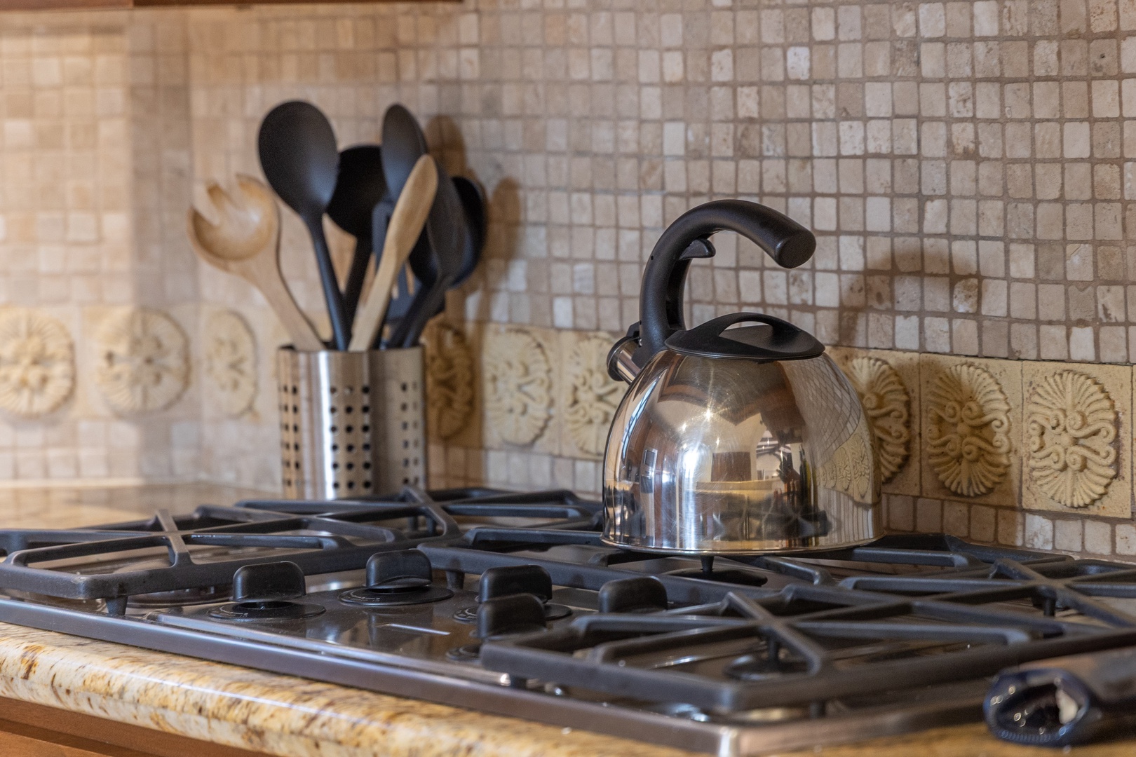Your fully-equipped kitchen invites you to whip up memorable meals, complete with a gleaming gas range, a charming kettle, and stylish tile accents that add warmth and character.