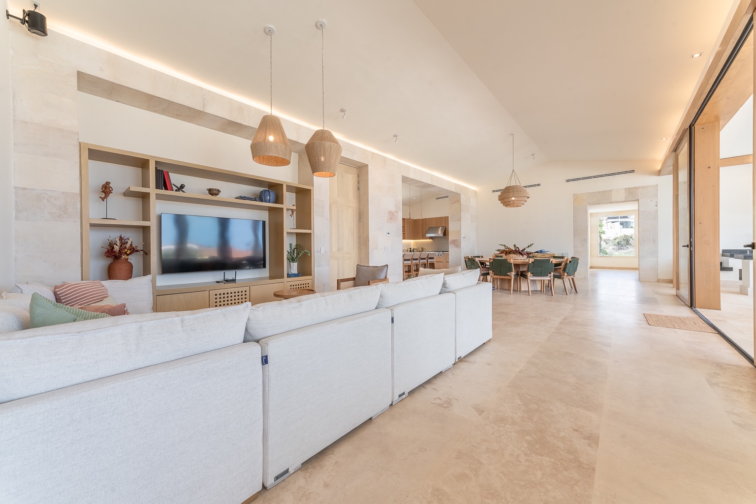 Unwind in your spacious, sunlit living area with vaulted ceilings, modern furnishings, and an open flow connecting you to the dining space and beyond.