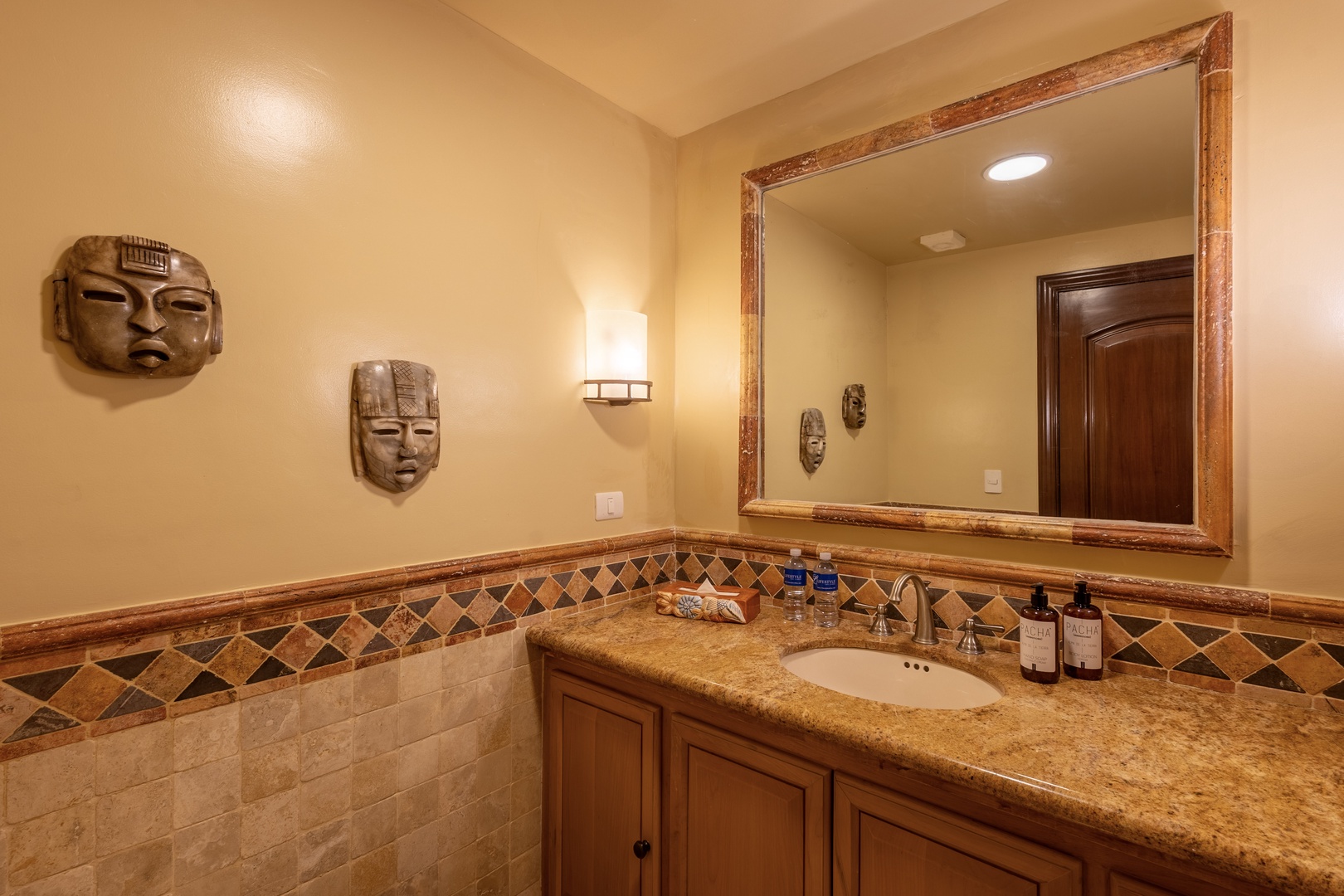 Refresh in your beautifully appointed bathroom with warm earth tones, artistic accents, and a spacious granite vanity stocked with premium amenities for your comfort.