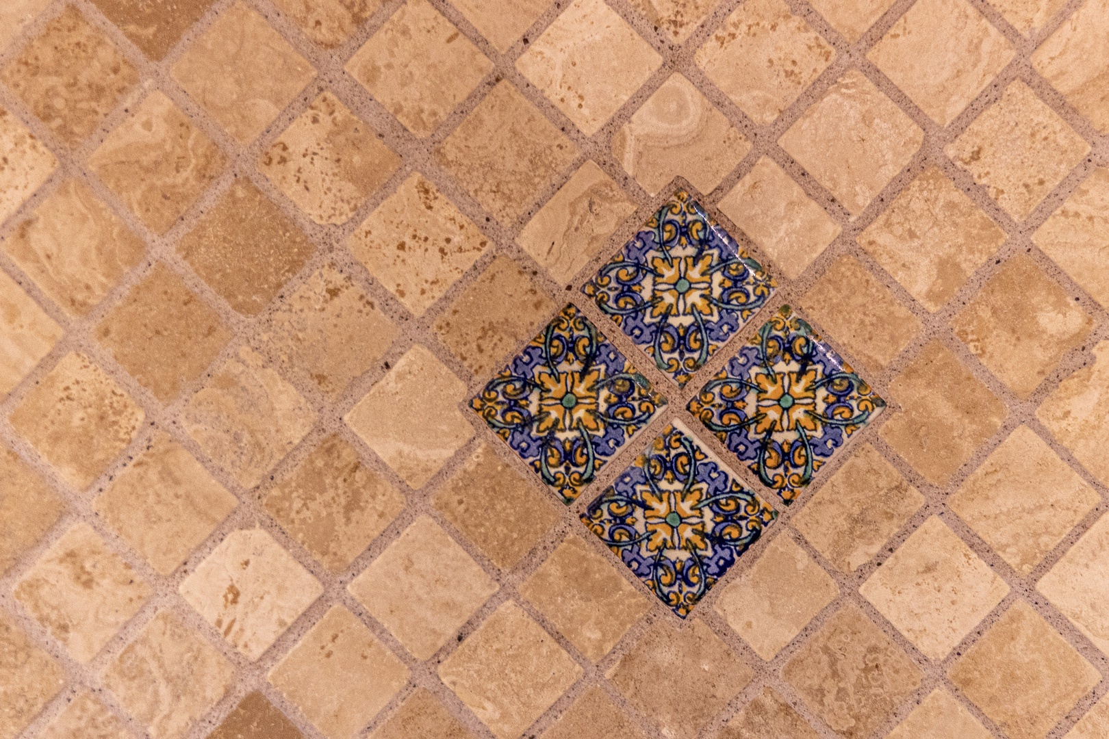 Handcrafted decorative tiles add a touch of artisan charm to the warm terracotta flooring, creating a welcoming space for your stay.