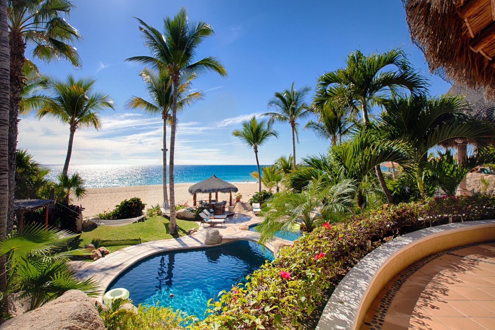Beachfront paradise with private pool surrounded by swaying palms, where tropical luxury meets pristine white sand and turquoise waters.